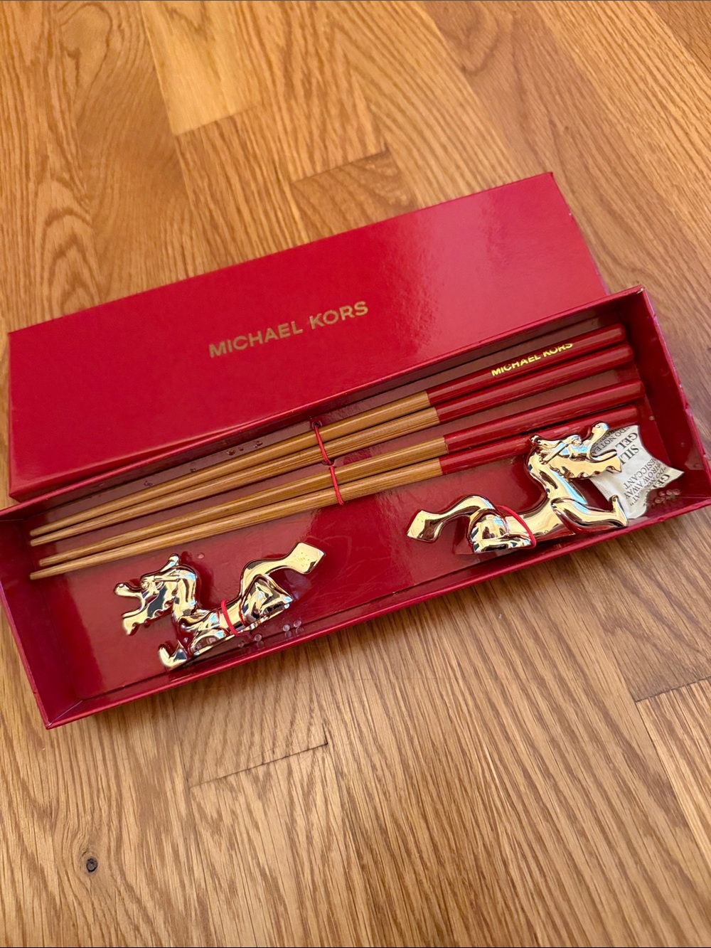 Michael Kors Red and Gold Decorative Chopstick Set with holders.